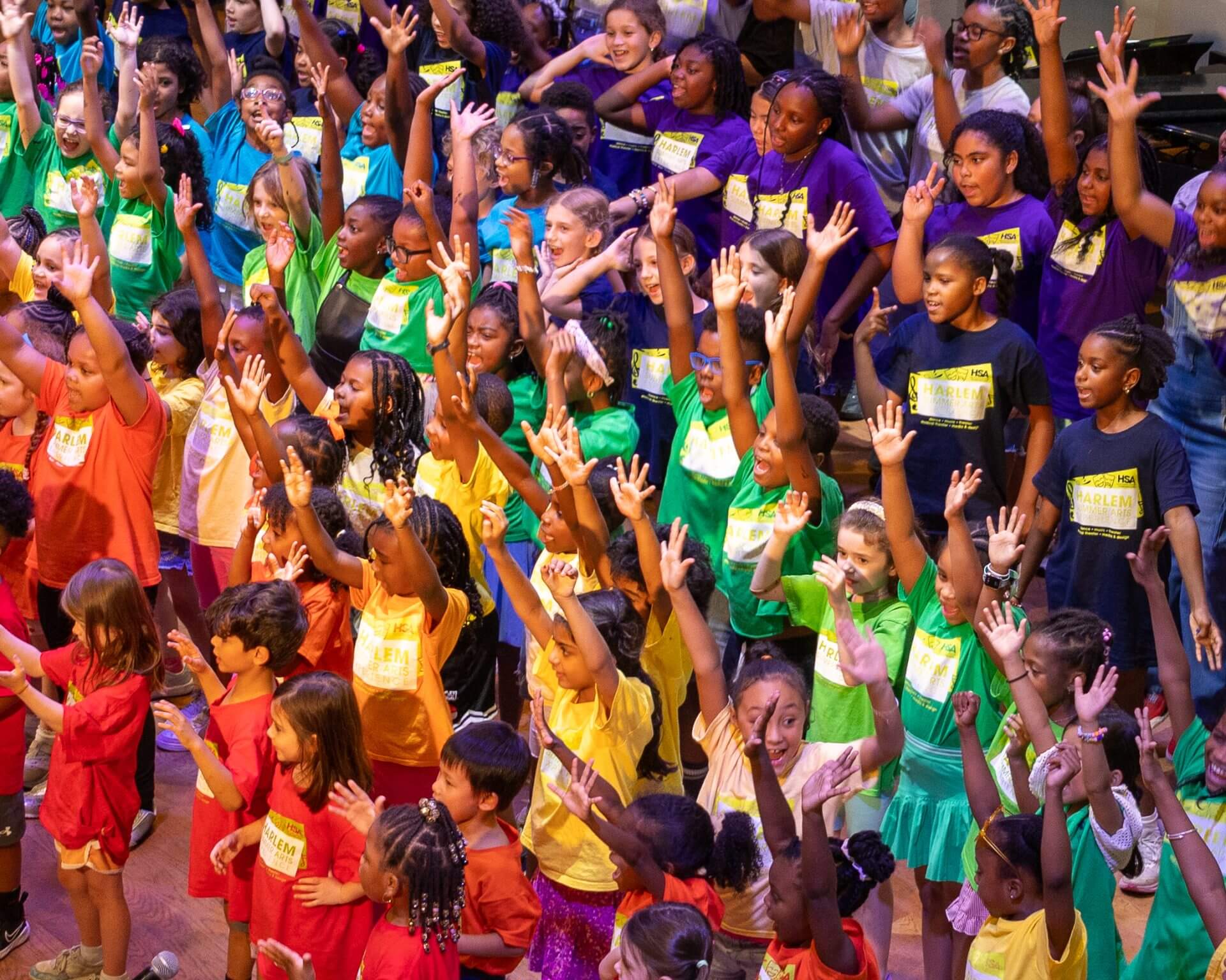 Children with hands raised at Harlem School of the Arts